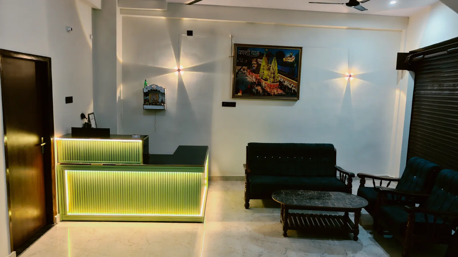 Welcoming reception lobby at Your Choice Homestay with seating area and Kashi Vishwanath artwork