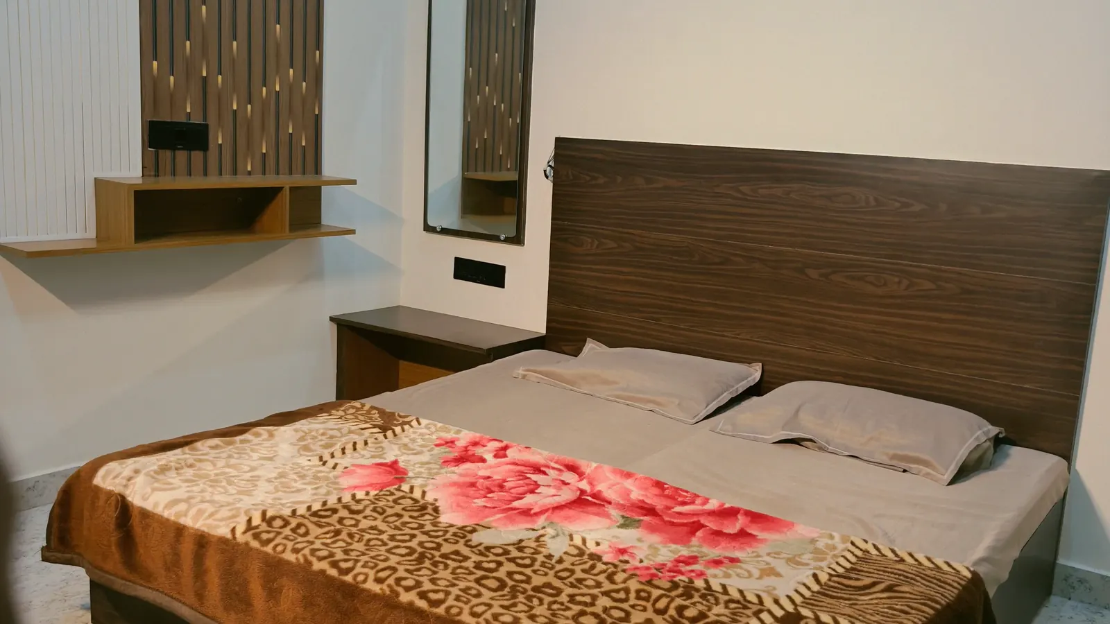 Wide-angle view of the AC double bedroom at Your Choice Homestay in Varanasi